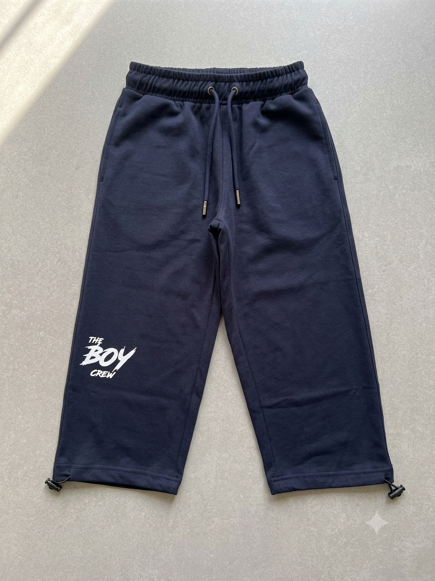 Navy The Boy Crew streetwear joggers with drawstring waist, side pockets, white logo print, and adjustable ankle toggles