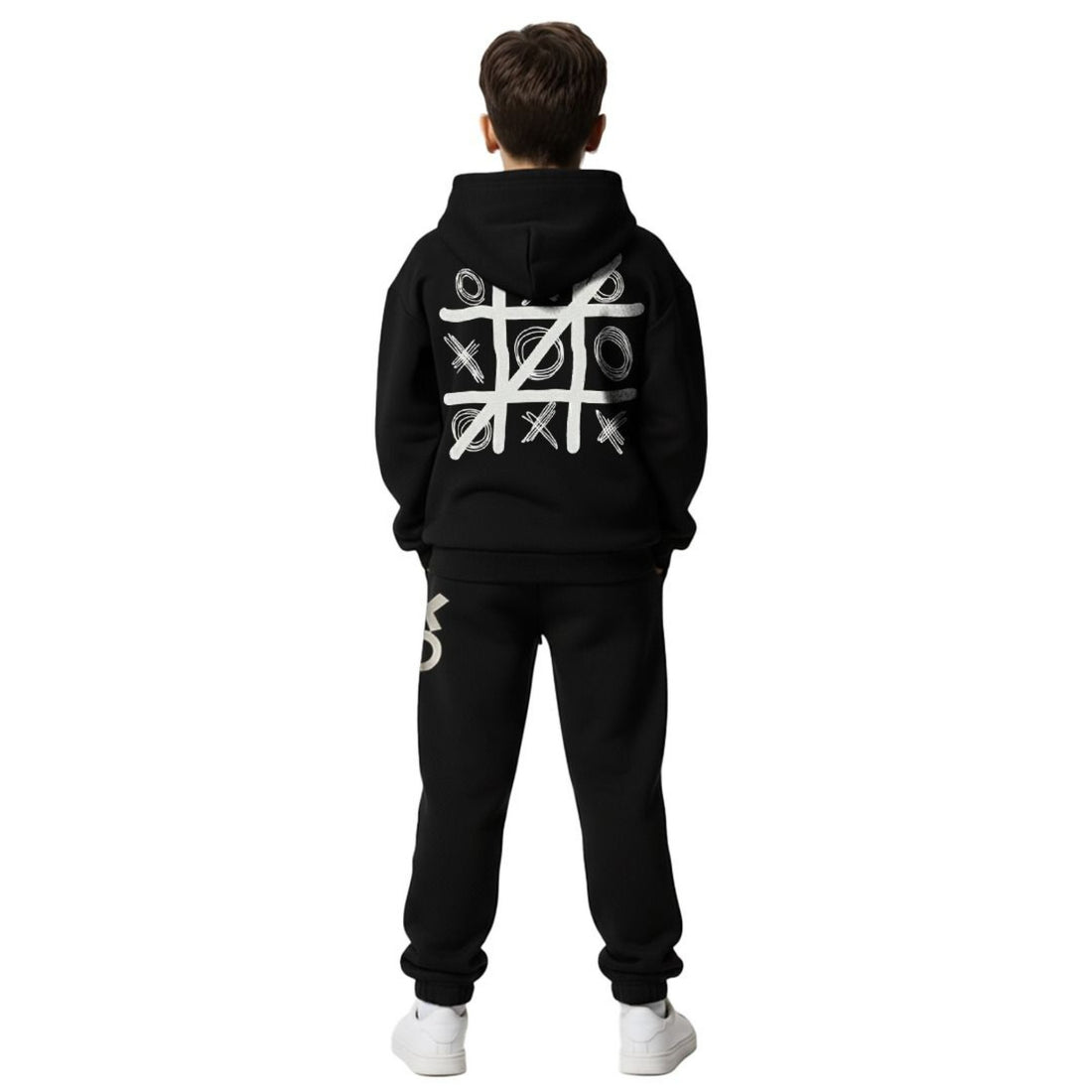 Boy wearing black tic-tac-toe hoodie and jogger set with blue chest patch and XO print on leg